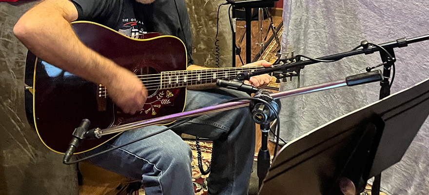 Steve playing guitar, cropped, in the studio